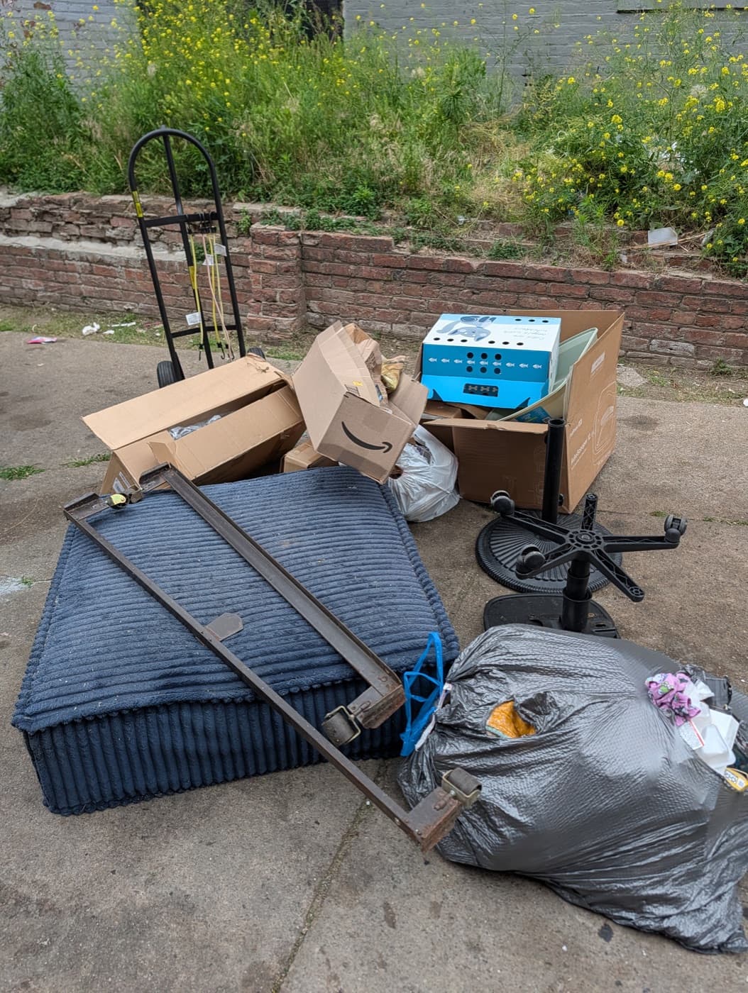 A pile of junk and debris left in a downtown Omaha alley before pickup